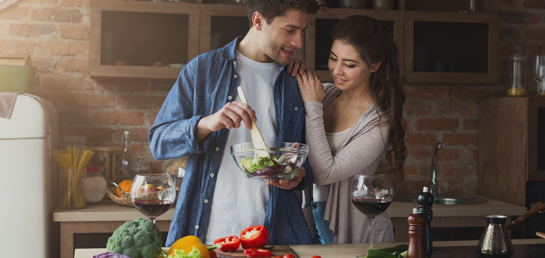 Couple making a healthy salad in the kitchen