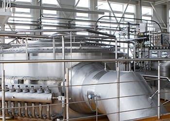 milk processing equipment inside a factory