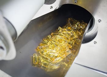 fish oil capsules in production machine
