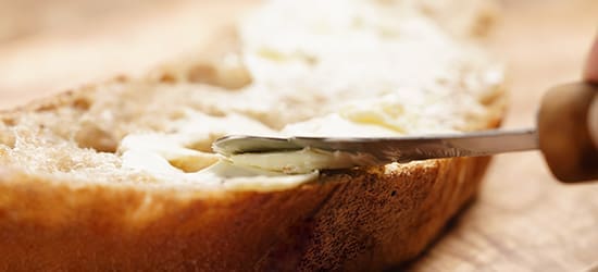 Butter being spread on bread