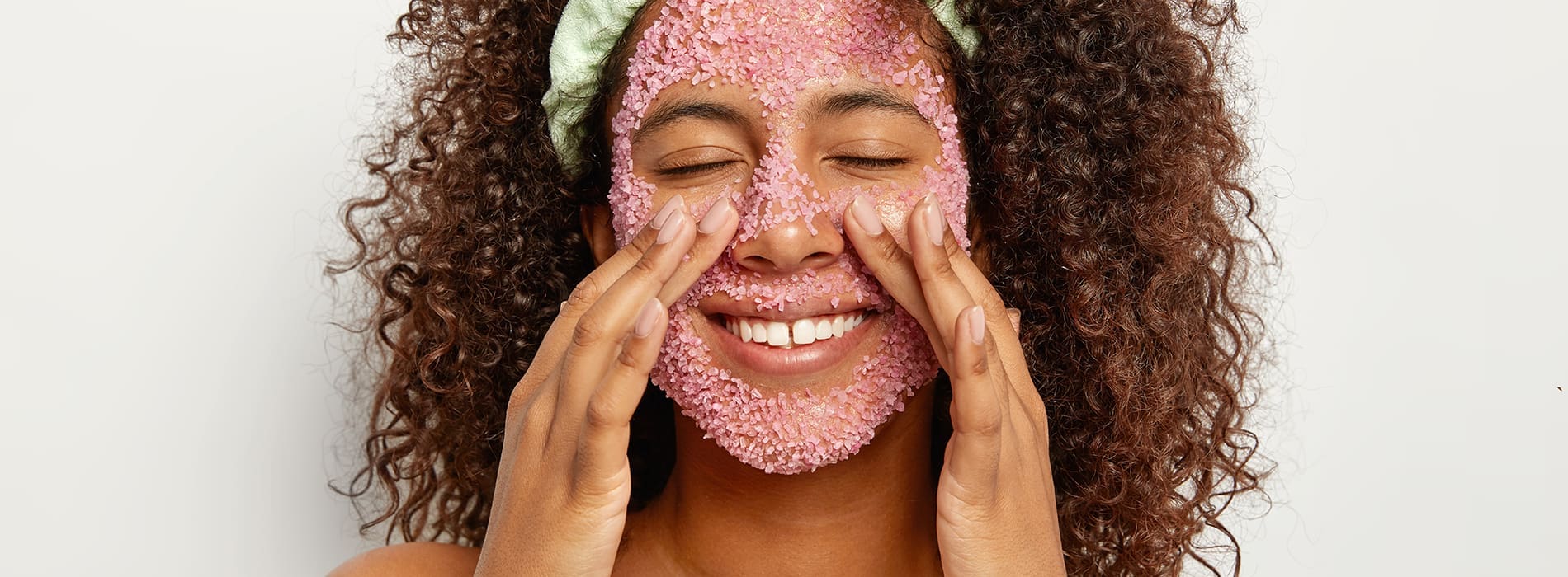 Woman applying a skincare facemask