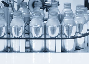 Small aluminium bottles on a production line